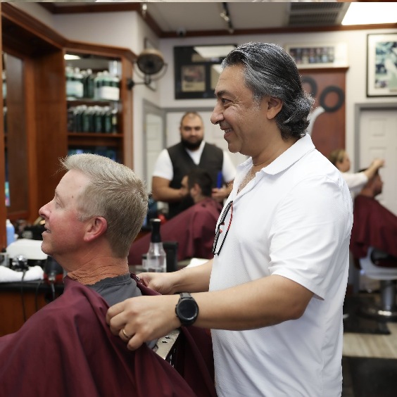 Inside Classic Barbershop — warm walnut and pendant light